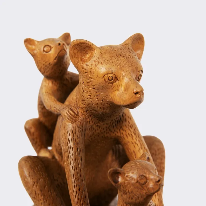 Handcrafted artisan wooden statue of a lemur family with a smooth finish.