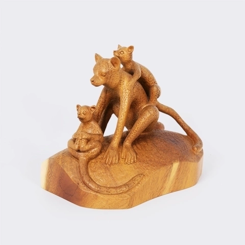 Handcrafted artisan wooden statue of a lemur family with a smooth finish.