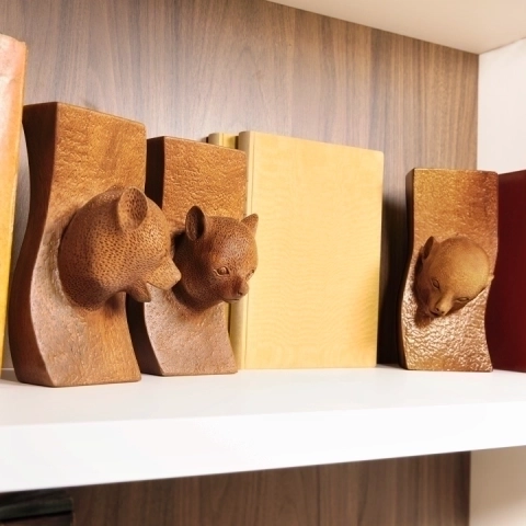 Luxury library decoration: a set of lemur sculptures elegantly placed on a modern shelf.