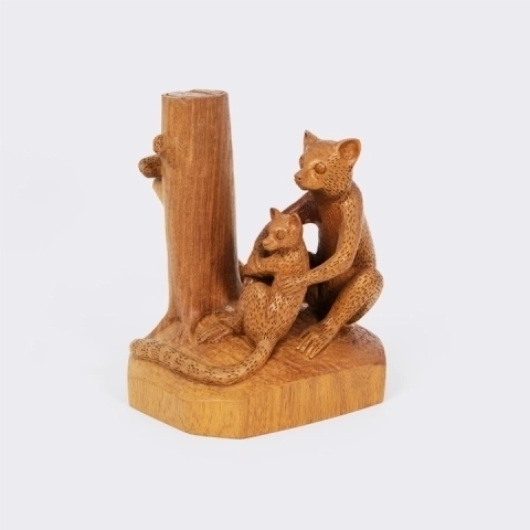  Elegant handcrafted statue from Madagascar, with a smooth finish, depicting a mother lemur and her baby sitting near a tree trunk.