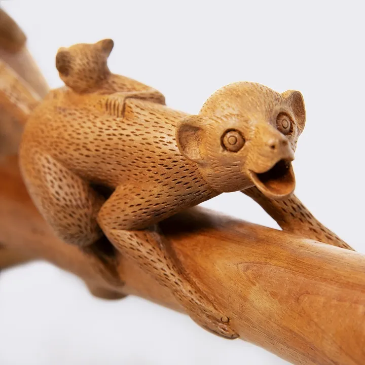 Elegant handcrafted statue depicting a mother Maki (lemur) climbing a tree trunk with her baby, made in Madagascar.