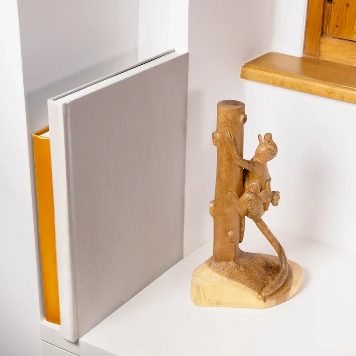 Elegant handcrafted statue depicting a mother Maki (lemur) climbing a tree trunk with her baby, made in Madagascar.