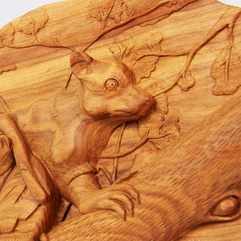 Close-up of the lemur mother's head, highlighting the precision of the handcrafted carving, the natural texture of the wood, and the smoothness of a perfectly smooth finish.