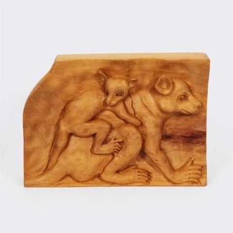 Handcrafted wooden bas-relief panel depicting a mother lemur ‘Maki’ carrying her baby, an artisanal artwork from Madagascar