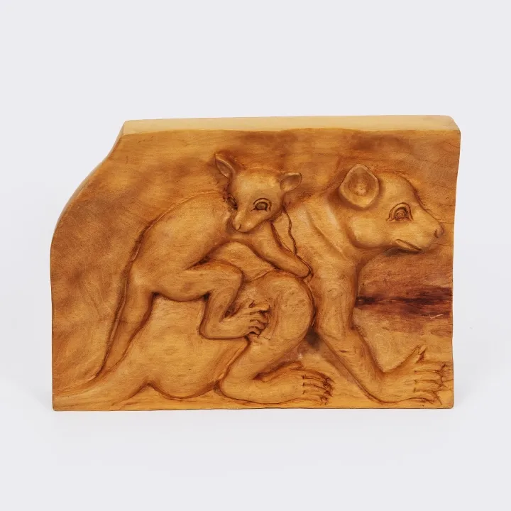 Handcrafted wooden bas-relief panel depicting a mother lemur ‘Maki’ carrying her baby, an artisanal artwork from Madagascar