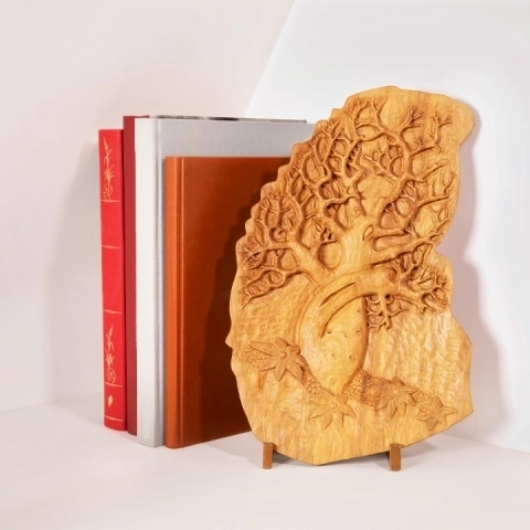 Sophisticated library decor: Artisan wooden relief plaque of the legendary Madagascar Baobab tree displayed on a stand 