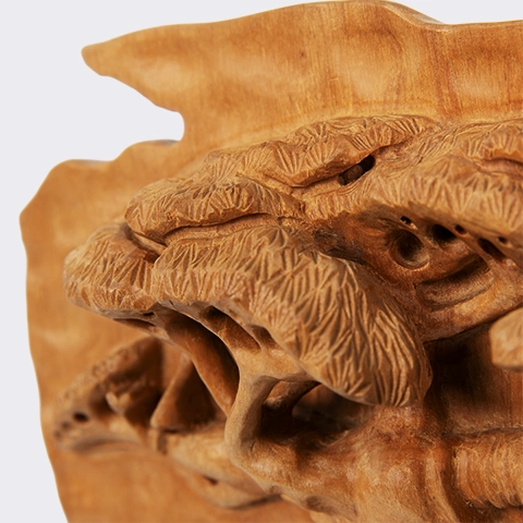 Close-up of a hand-carved wooden bas-relief depicting the textured canopy and branches of a majestic baobab tree, highlighting the painstaking carving, finish, and refined details.