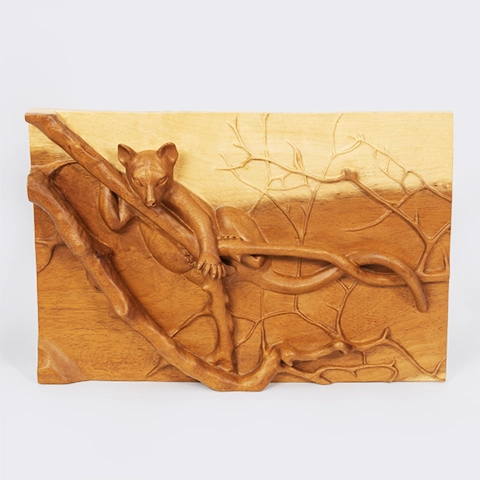 A refined work of animal art from Madagascar: a hand-crafted wooden bas-relief panel depicting a fossa