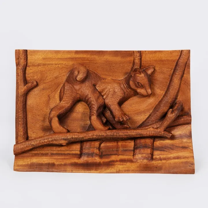 Authentic wildlife art from Madagascar: Handcrafted wood bas-relief panel depicting a Fossa cub walking on a tree branch.