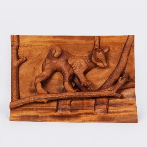 Authentic wildlife art from Madagascar: Handcrafted wood bas-relief panel depicting a Fossa cub walking on a tree branch.