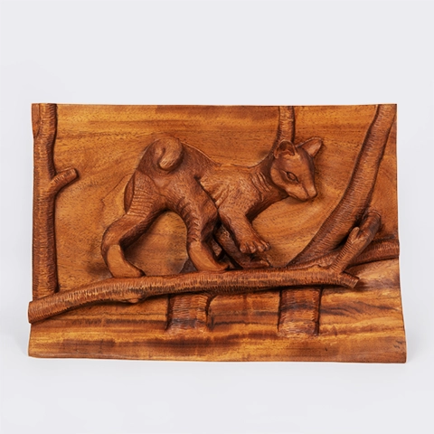 Authentic wildlife art from Madagascar: Handcrafted wood bas-relief panel depicting a Fossa cub walking on a tree branch.
