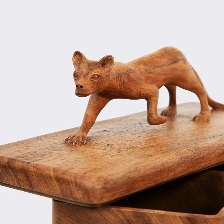 Handcrafted decorative wooden box adorned with a carved Madagascar fossa on the lid.
