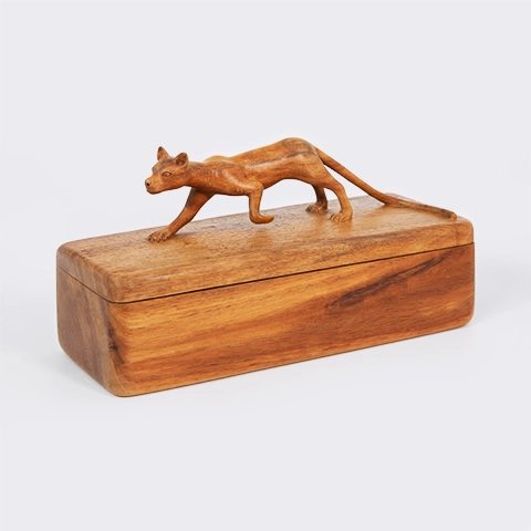 Handcrafted decorative wooden box adorned with a carved Madagascar fossa on the lid.
