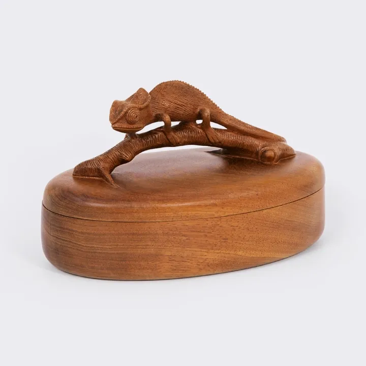 Hand-carved oval decorative box made of precious wood, featuring a detailed Madagascar Chameleon sculpture as the lid handle.