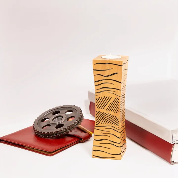 Single modern artisan wooden candle holder with abstract black line art design.