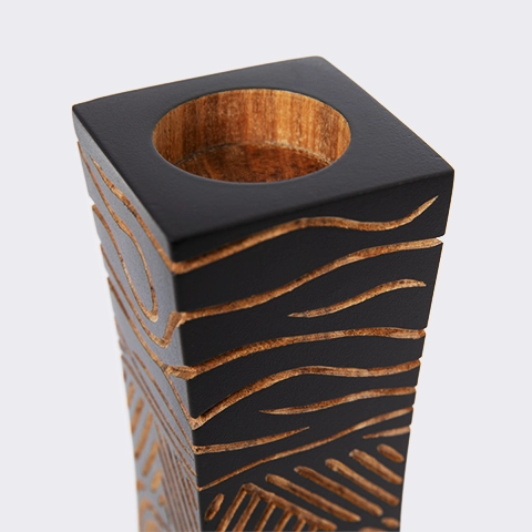 Close-up of the candlestick, showing the hand-carved abstract line art design, highlighting the craftsmanship and perfection of the sculpture