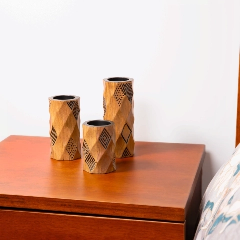 Modern bedroom decor: Elegant rounded wooden candlestick, with hand-carved geometric lines and a black painted finish.