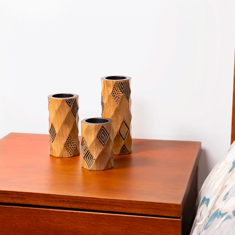 Modern bedroom decor: Elegant rounded wooden candlestick, with hand-carved geometric lines and a black painted finish.