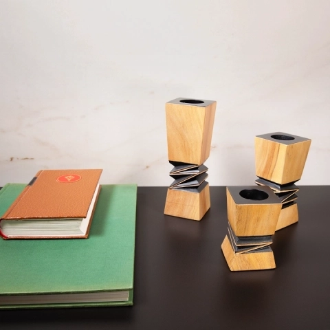 Contemporary home office decor: Set of three geometric wooden candlesticks with black accents.
