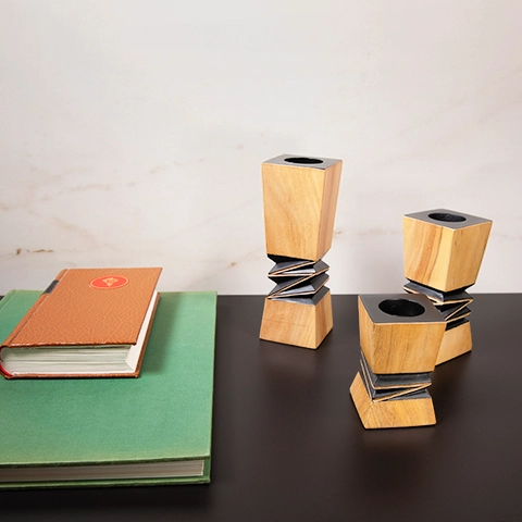 Contemporary home office decor: Set of three geometric wooden candlesticks with black accents.
