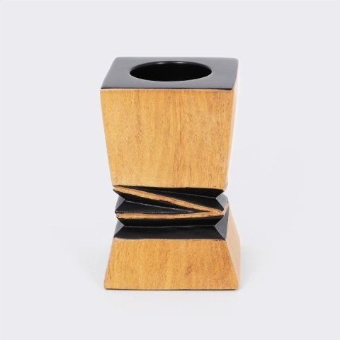 Handcrafted architectural wooden candlestick with a contrasting black geometric relief in the center.