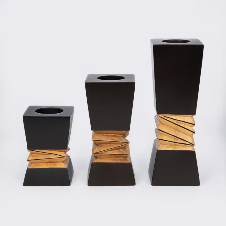 Handcrafted modern candle holder featuring a black top and bottom with a central geometric natural wood carving