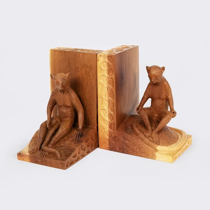 Pair of handcrafted bookends in wood, forming an L, with sculptures of lemurs in a seated position.