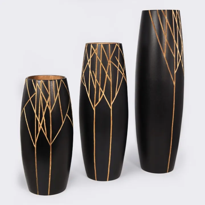 Madagascar Collection of three handcrafted wooden vases in different sizes, featuring a nature-inspired design that blends black and natural wood.