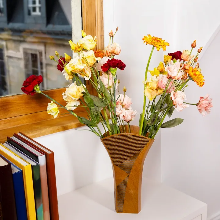 Bright floral arrangement in a handcrafted 'Meva' wooden vase