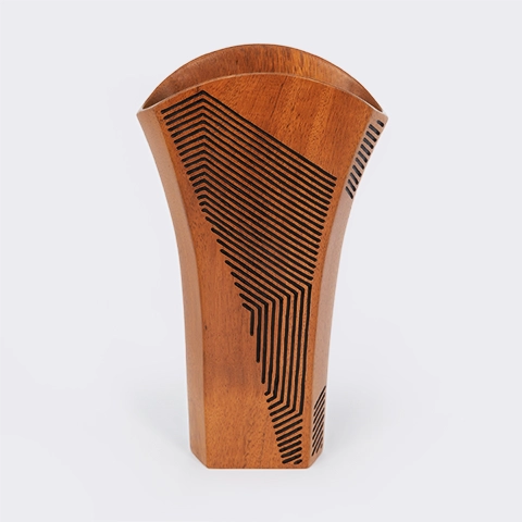 Single handcrafted wood vase with a flared rim and intricate black linear geometric engravings, artisan design from Madagascar.