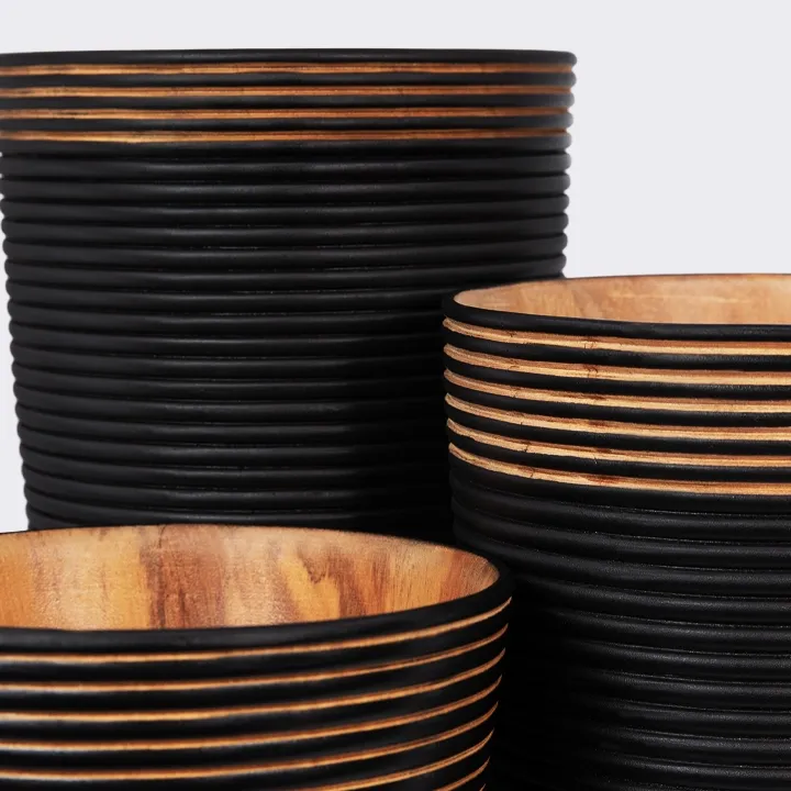 Conical wooden vase, handcrafted, with a matte black finish and sculpted horizontal ribs.