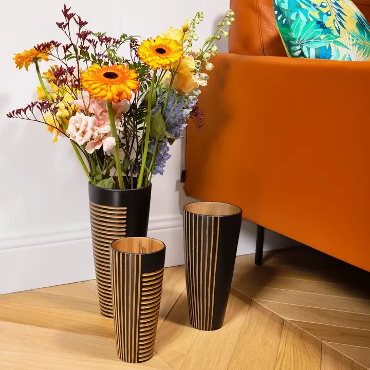 Modern living room decor: set of three graphic black wooden vases.