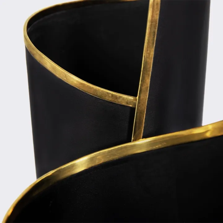 Close-up of the Skyscraper vase, matte black finish enhanced with a luxurious hand-applied brass trim. 