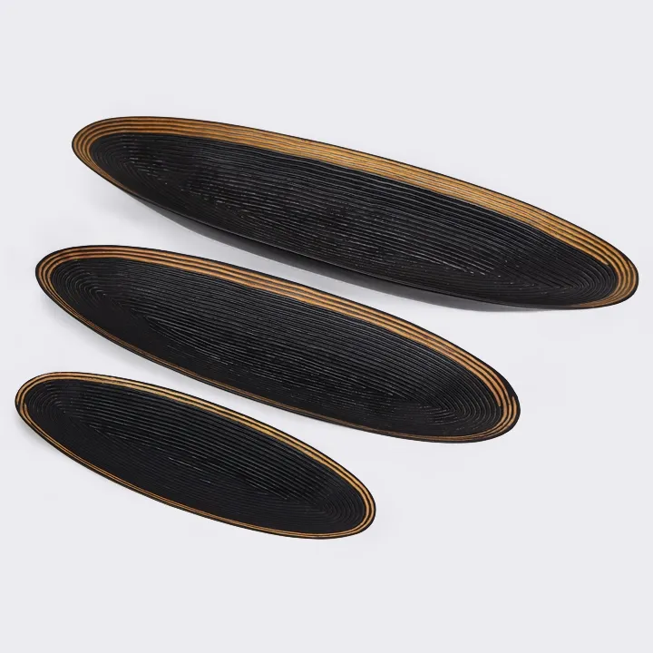 Modern table setting: a set of three nesting oval trays in black wood