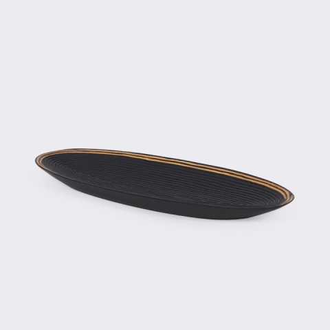 Oval tray in sohihy wood, handcrafted in Madagascar, with a textured, ribbed black surface.