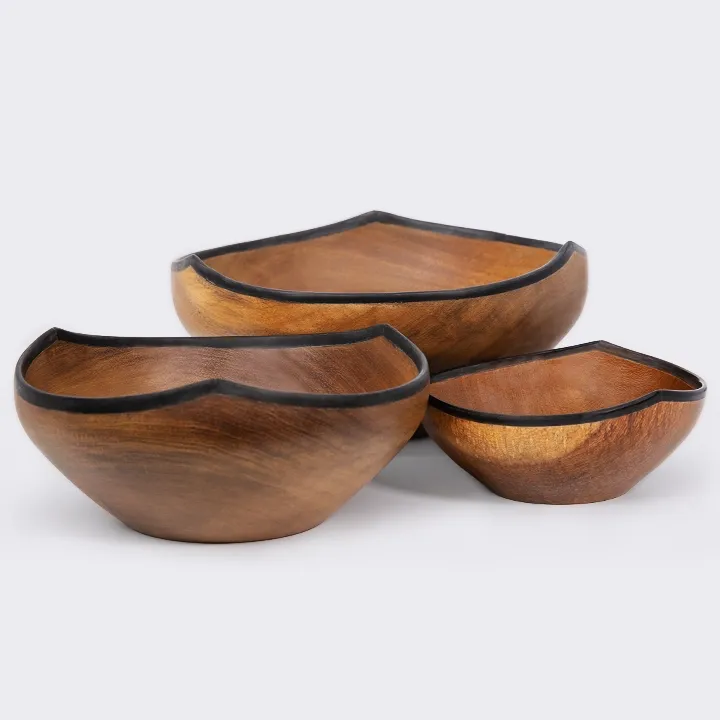 Rotating view of the  Trio of handcrafted wooden serving bowls with a sculptural water lily shape and contrasting horn rim.