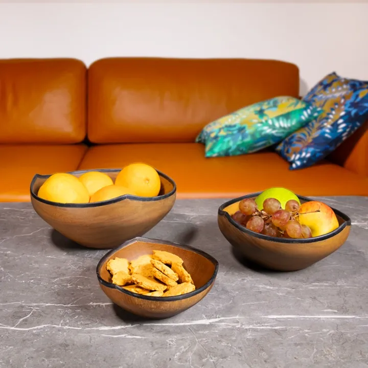 Elegant centerpiece: a wooden fruit bowl shaped like a water lily, edged with horn, perfect for holding fresh fruit.