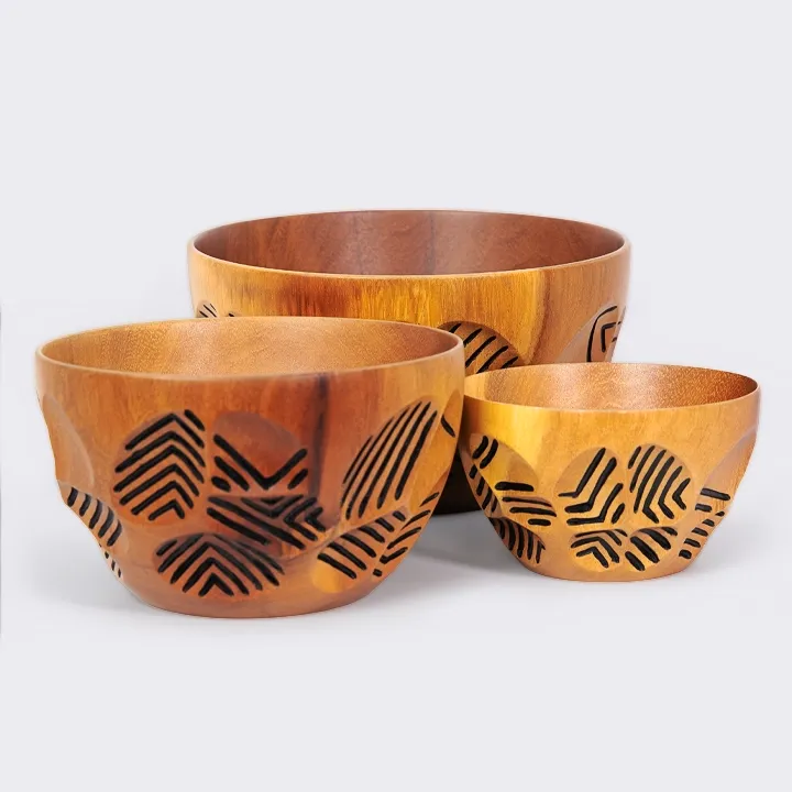 Rotating view of the Single round sohihy wood bowl featuring a tribal-inspired black leaf engraving design.