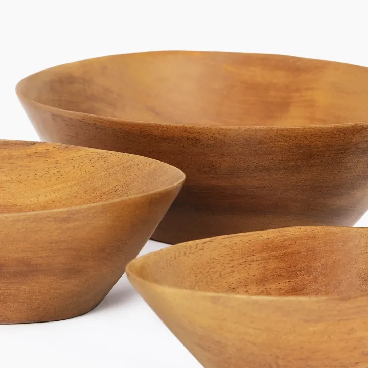 Rotating view of the set of three oval nesting bowls, handcrafted from sohihy wood with a natural finish. 