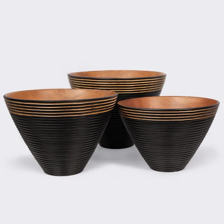 Trio of modern wooden salad bowls in different sizes, adorned with a pleasant-to-the-touch black grooved pattern.