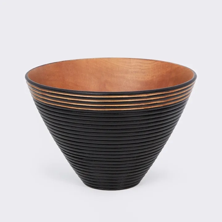 Handcrafted conical bowl in natural wood, with a matte black ribbed exterior and a natural gold interior.
