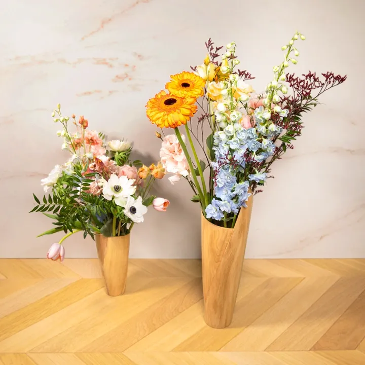 Rotating view of the Handcrafted tall wooden vase with a sculptural, asymmetrical rim on a white background.